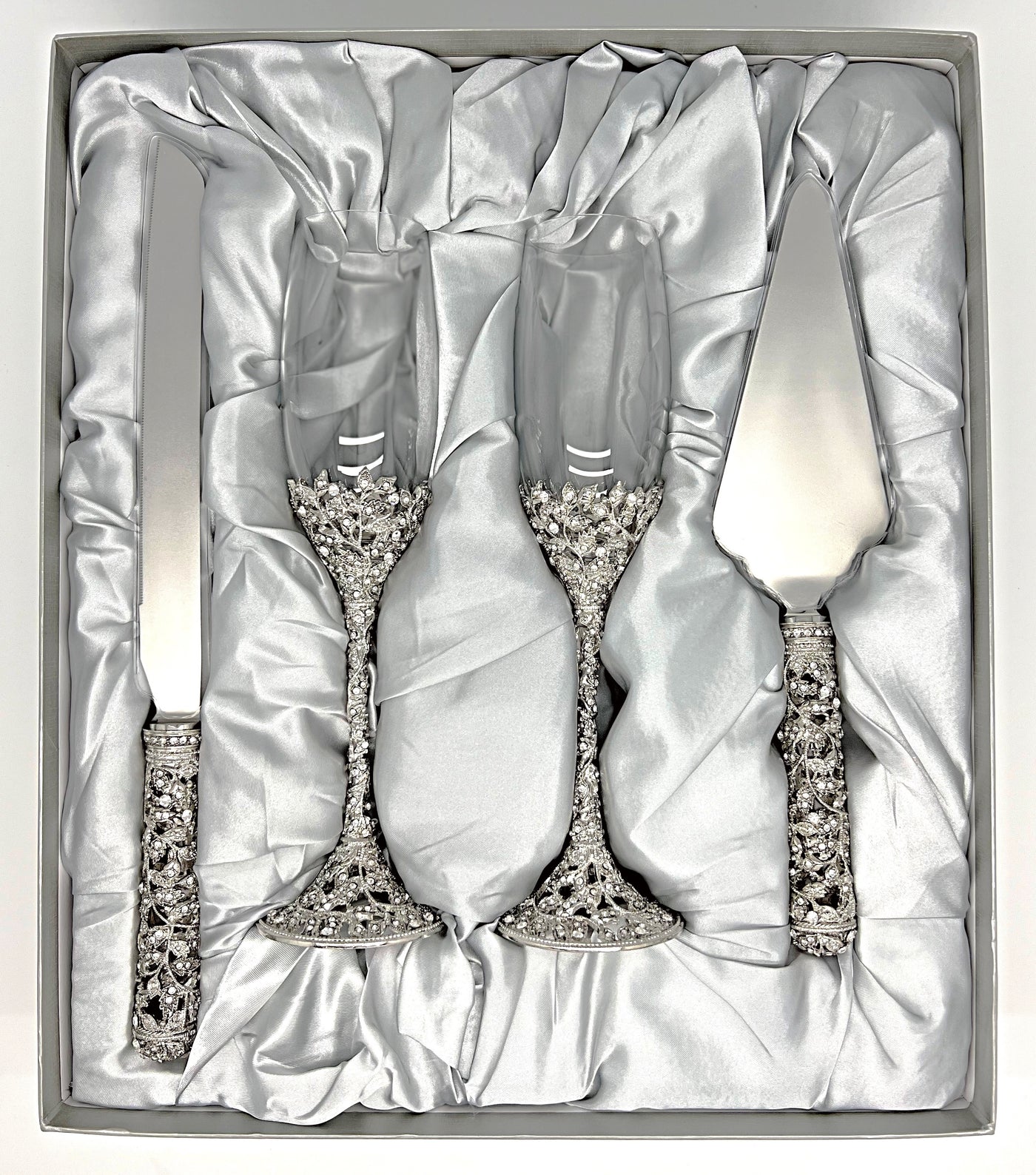 Toasting flutes and cake cutting set displayed in custom box 